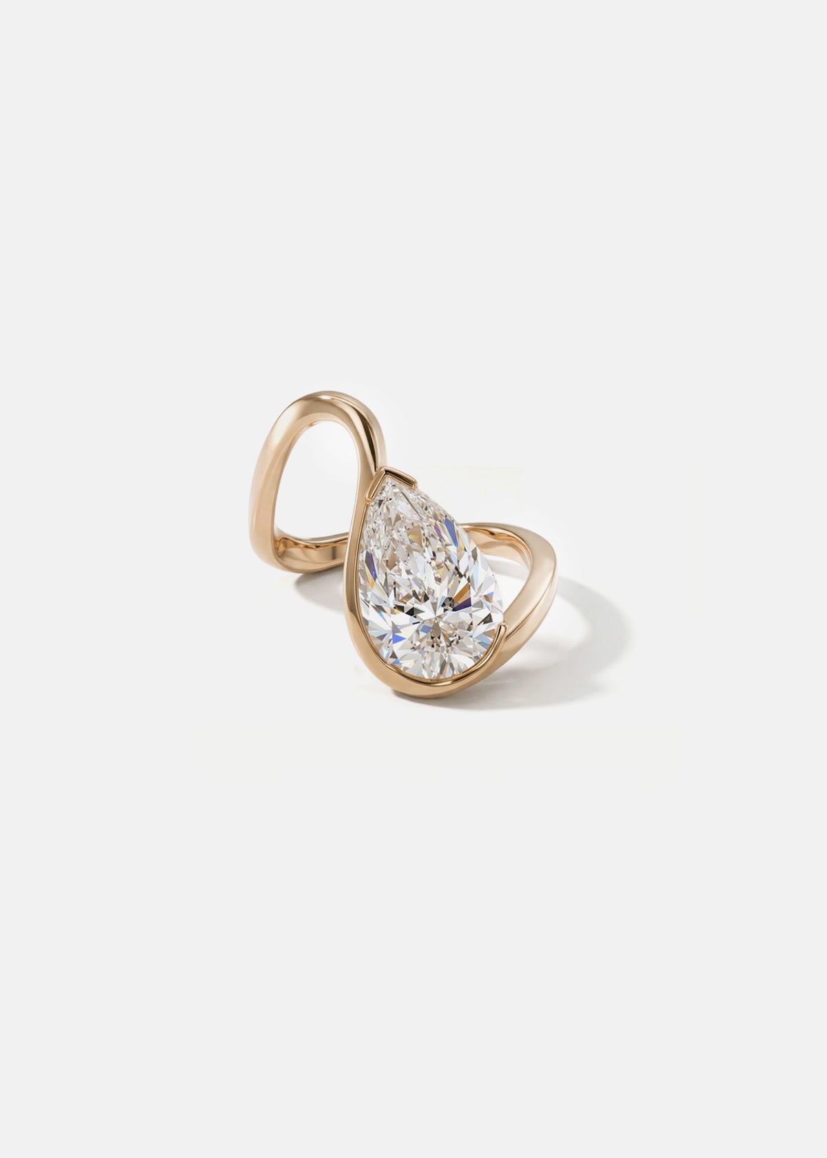 front view- 18k rose gold trace band with a floating pear cut diamond