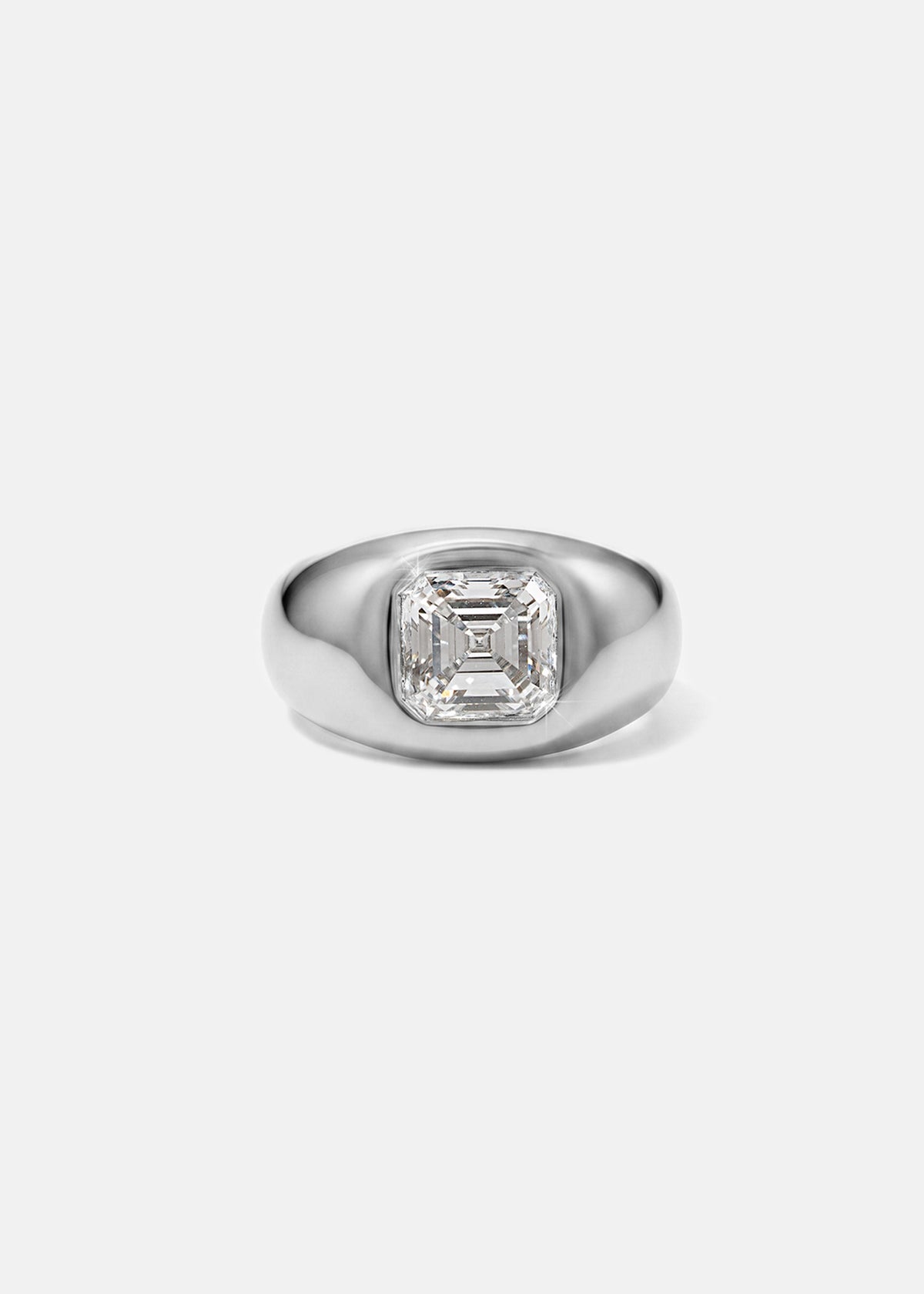 A 18k white gold signet ring featuring a large, bezel-set asscher cut diamond, against a clean background.
