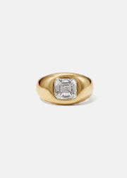 A 18k yellow gold signet ring featuring a large, bezel-set asscher cut diamond, against a clean background.