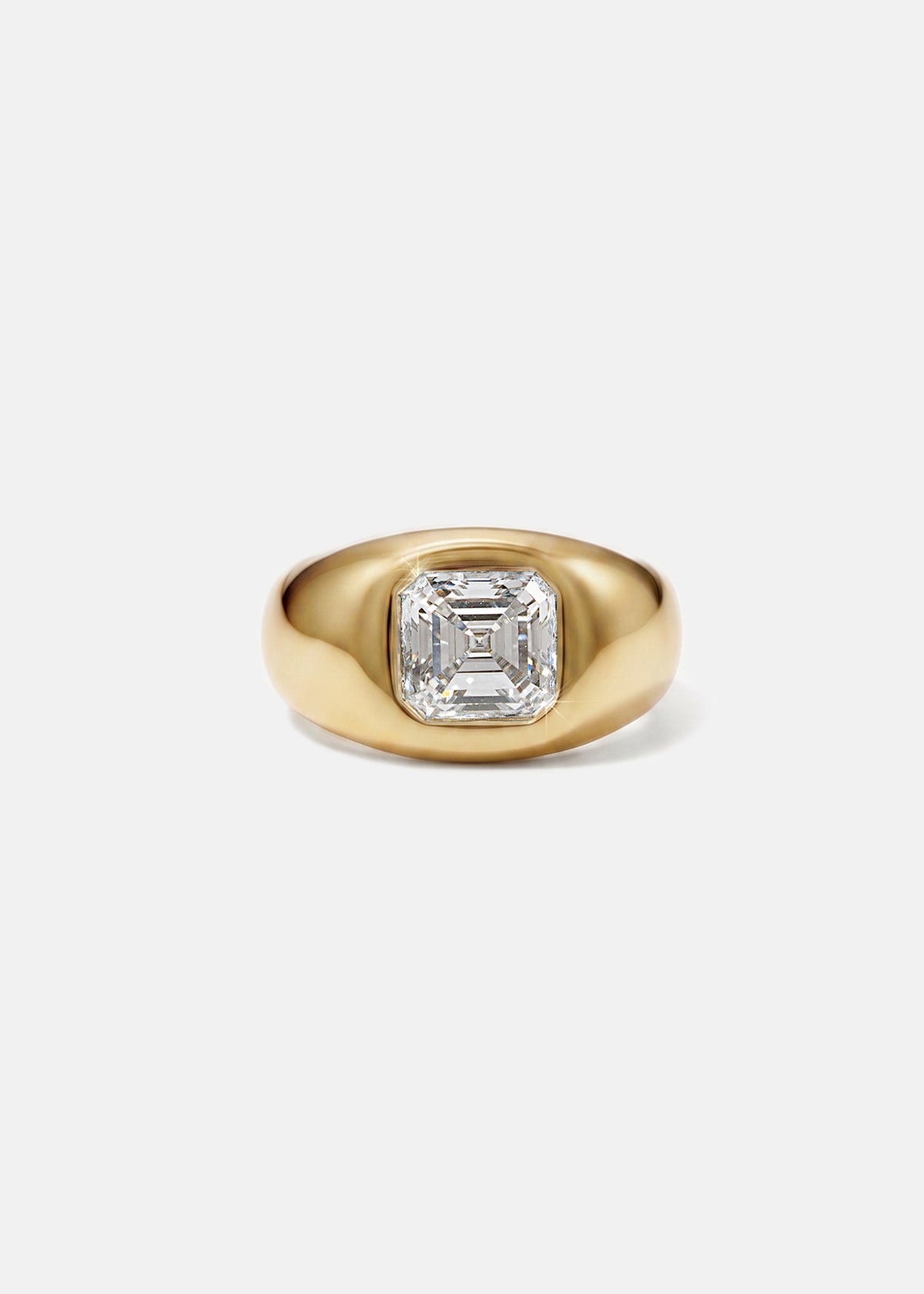 A 18k yellow gold signet ring featuring a large, bezel-set asscher cut diamond, against a clean background.