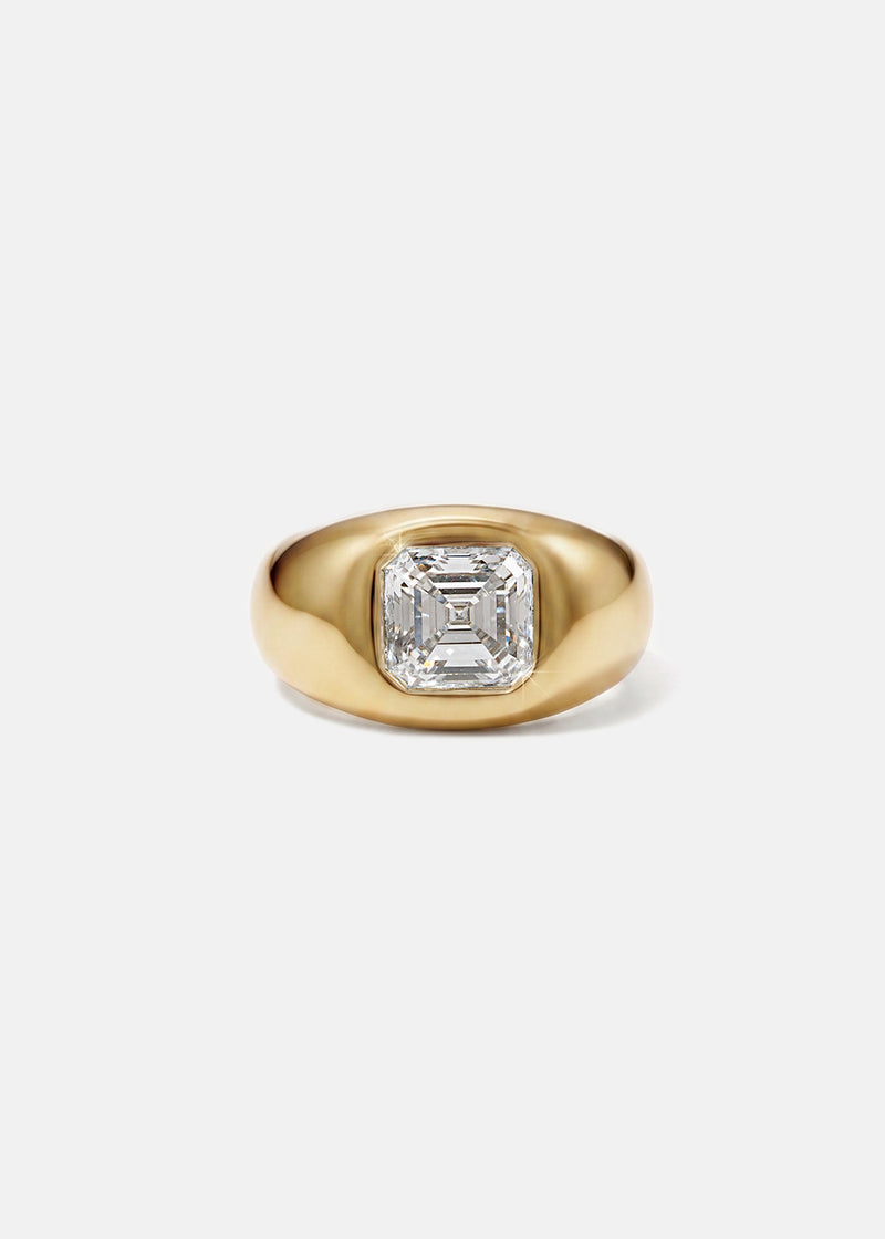A 18k yellow gold signet ring featuring a large, bezel-set asscher cut diamond, against a clean background.
