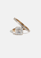 18k rose gold bypass ring featuring a floating asscher cut diamond and tapering channel of baguettes band.
