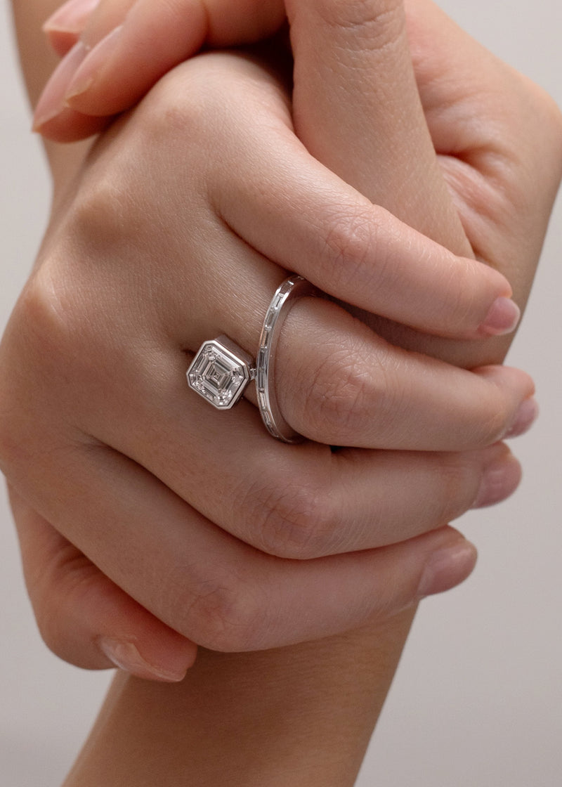 worn on the ring finger-18k white gold bypass ring featuring a floating asscher cut diamond and tapering channel of baguettes band.
