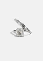 18k white gold bypass ring featuring a floating asscher cut diamond and tapering channel of baguettes band.