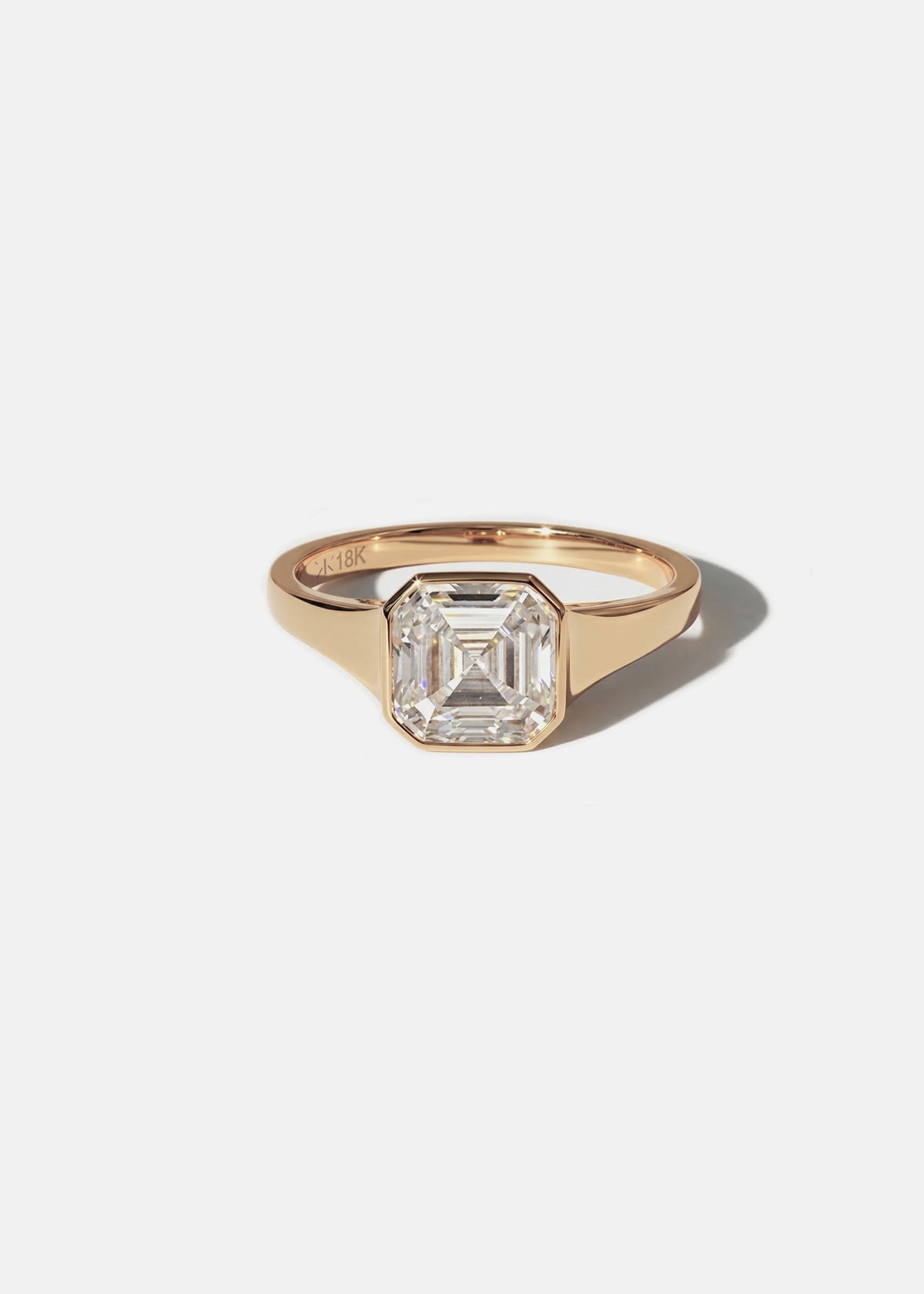 18k rose gold tapering gold band - with a bezel set asscher cut diamond 