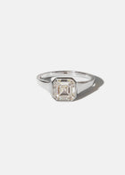18k white gold tapering gold band - with a bezel set asscher cut diamond 