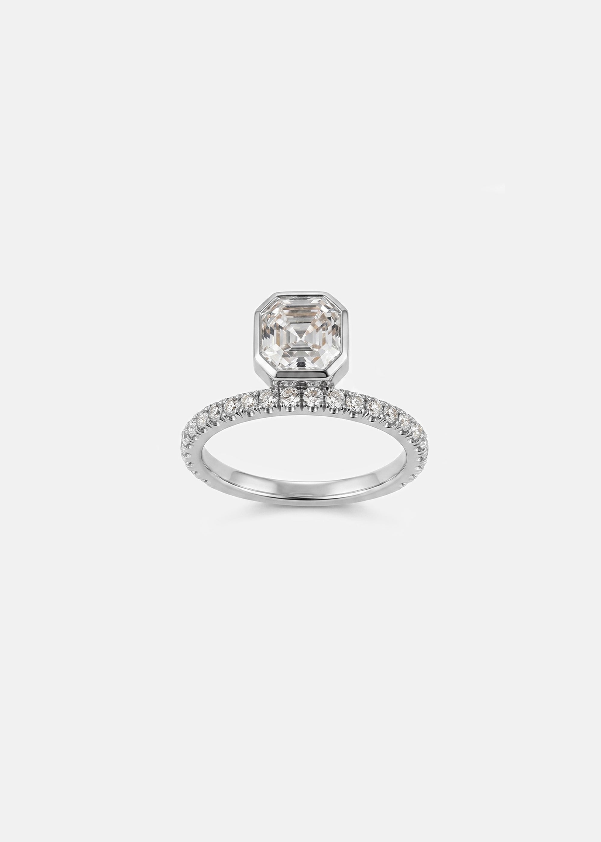 18k white gold engagement ring with a suspended floating asscher cut diamond and half pavé band