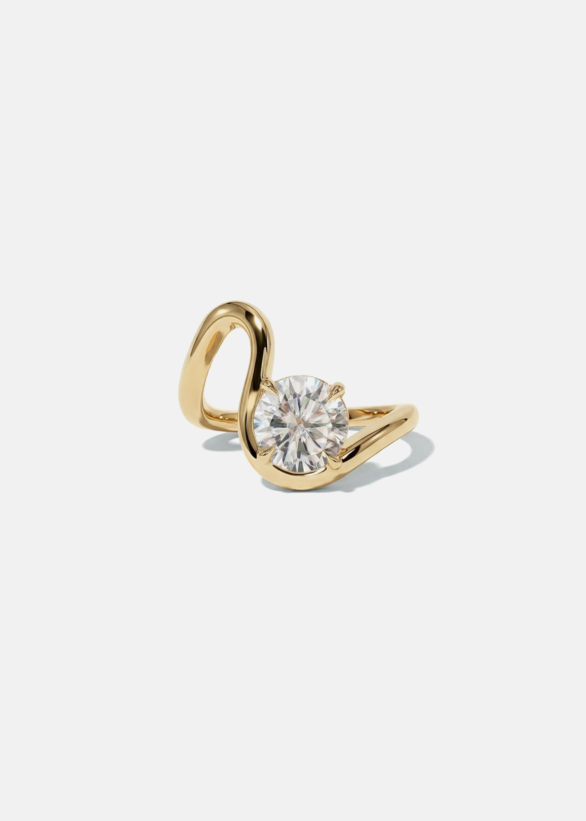 front view- a 18k yellow gold ring with a unique sculptural, flowing, wavy band nestling a large round cut diamond-clean light gray background-KATKIM-engagement ring-fine jewelry