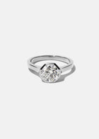 18k white gold architectural engagement ring with a round cut diamond in a thick, octagon bezel setting.