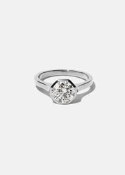 18k white gold architectural engagement ring with a round cut diamond in a thick, octagon bezel setting.