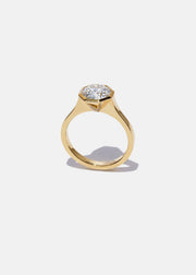 18k yellow gold architectural engagement ring with a round cut diamond in a thick, octagon bezel setting.
