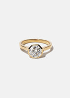 18k yellow gold architectural engagement ring with a round cut diamond in a thick, octagon bezel setting.