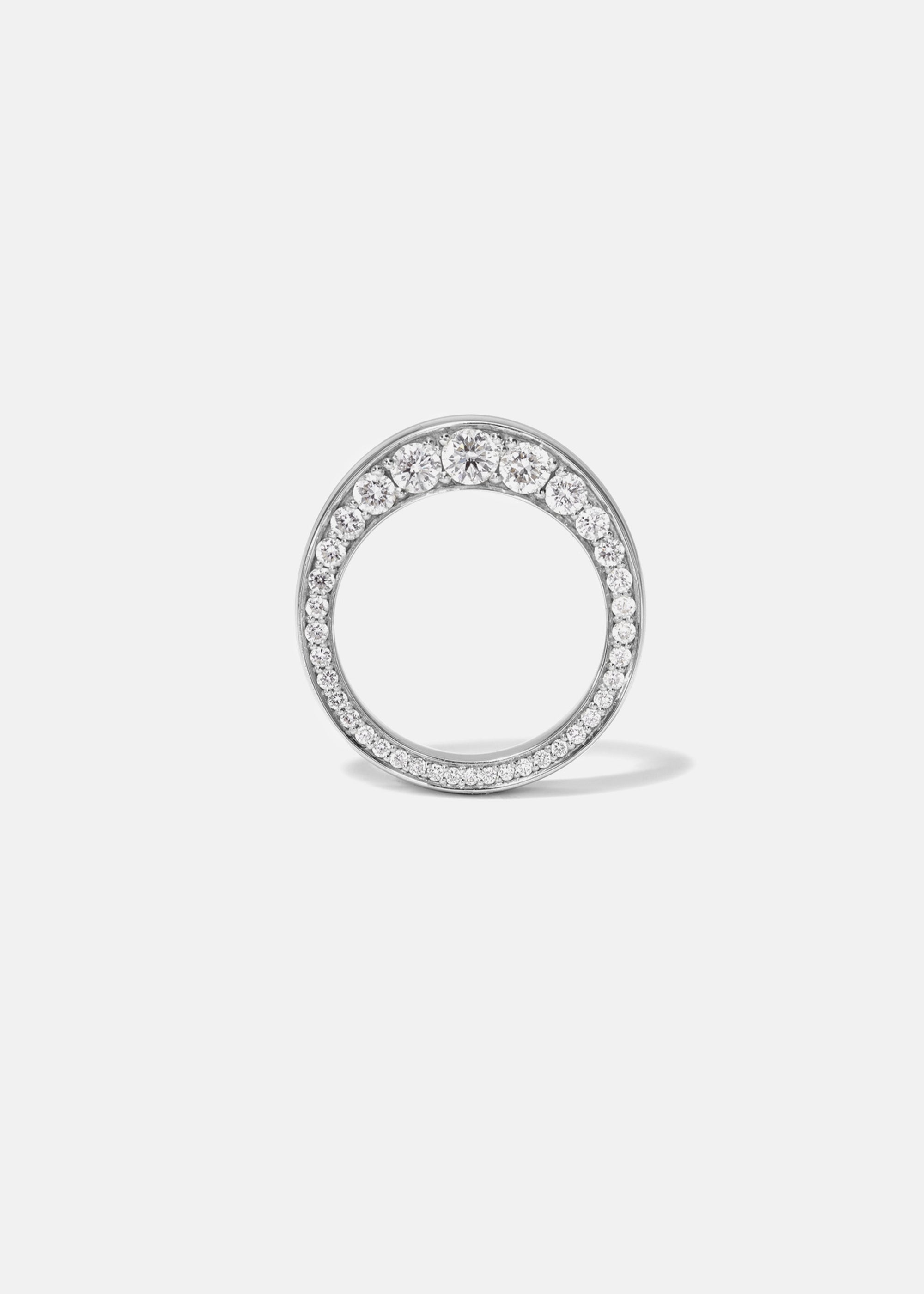 a 18k white gold ring featuring a tapering of round cut diamonds along the tapering gold band.