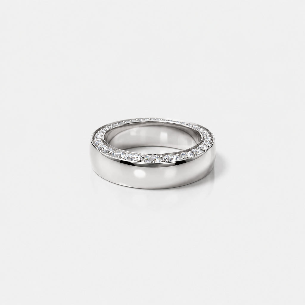 front view of a gold band with tapering diaomonds on the top.