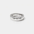 front view of a gold band with tapering diaomonds on the top.