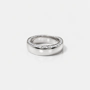front view of a gold band with tapering diaomonds on the top.
