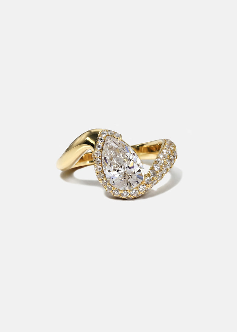  18k yellow gold ring featuring a pear-cut diamond in a curved, wave-like setting with pavé diamonds around the center stone