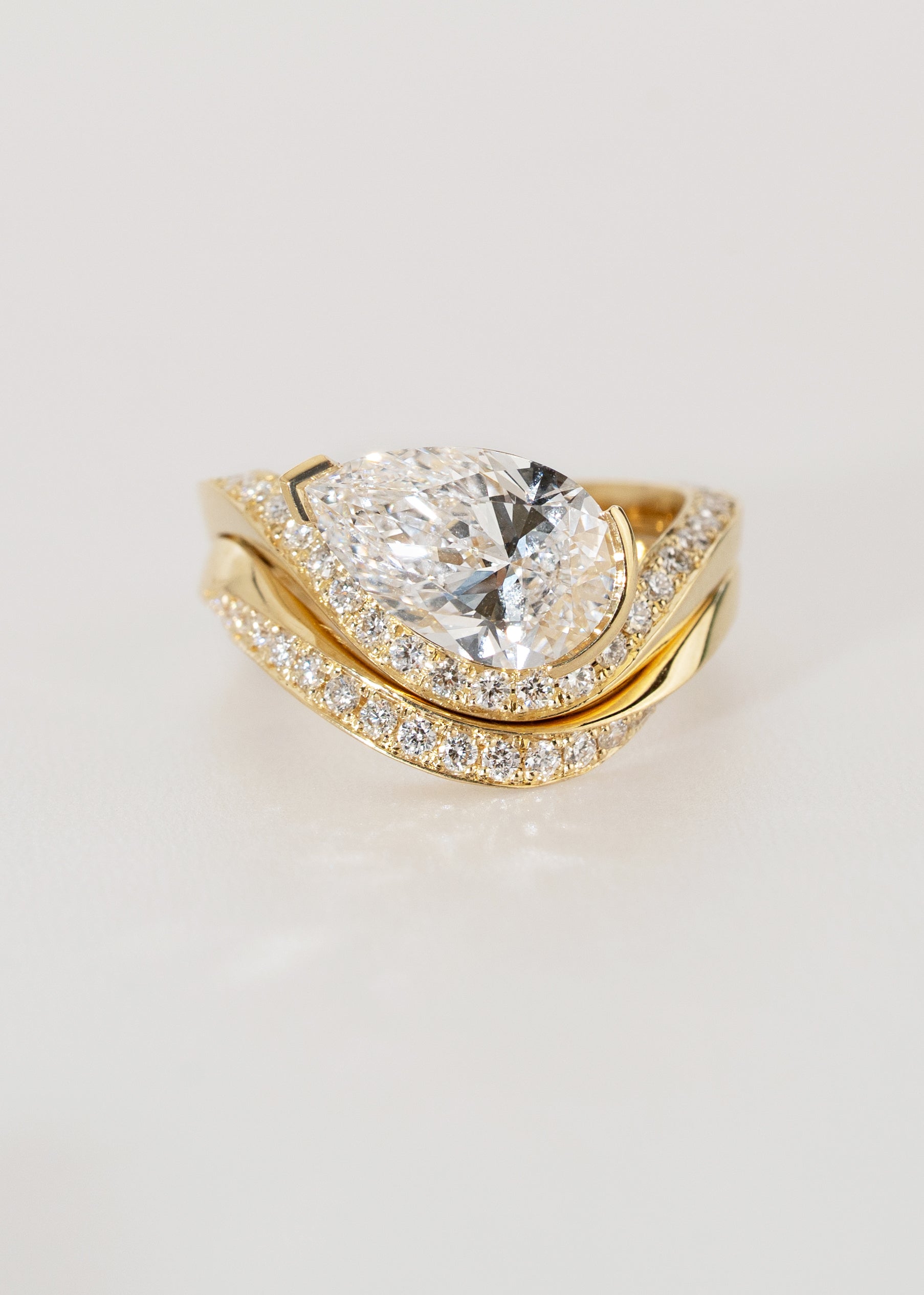 18k yellow gold ring- wave band with pavé diamonds- pear cut diamond- engagement ring- paired with a matching pavé gold band