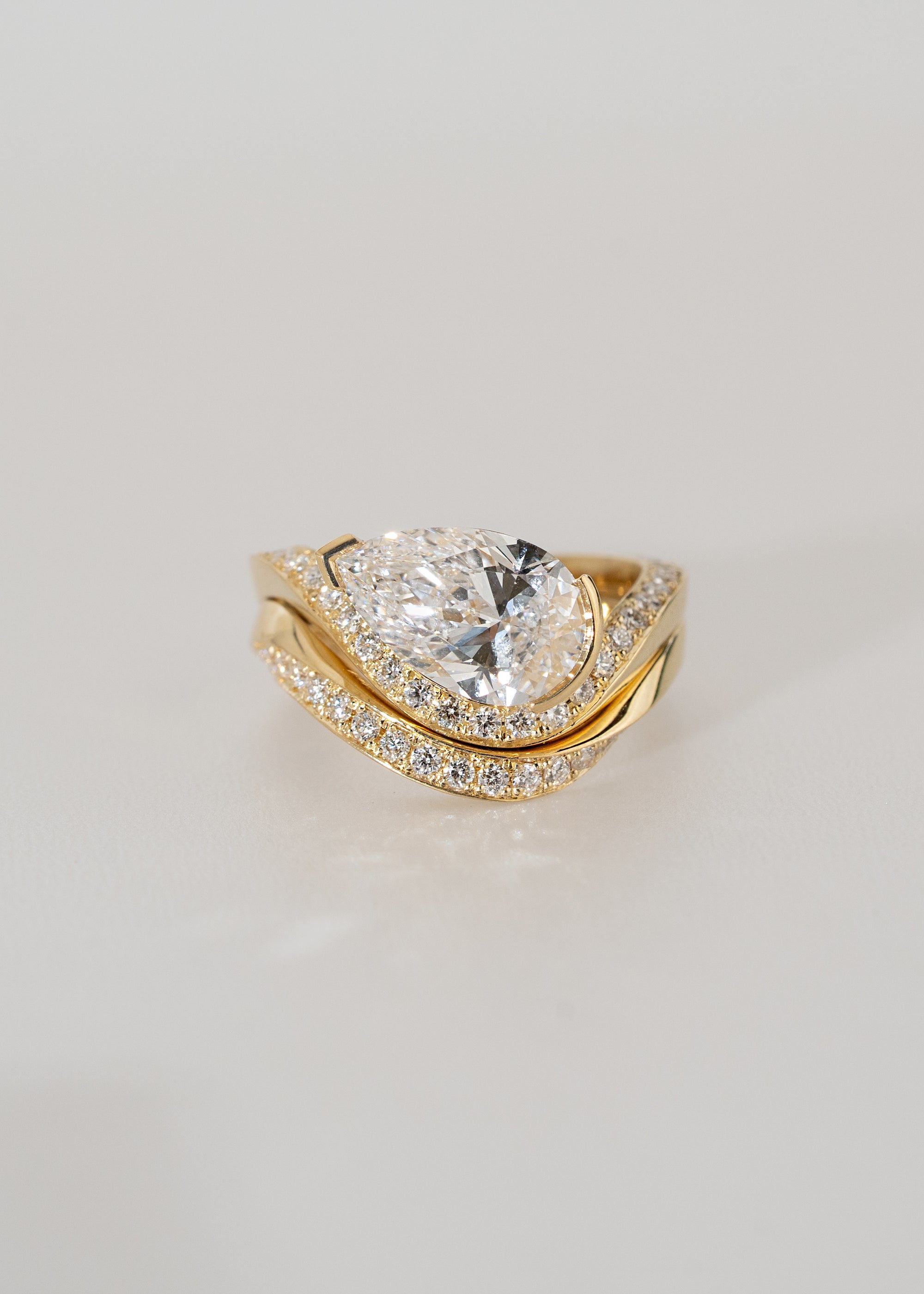 18k yellow gold ring- wave band with pavé diamonds- pear cut diamond- engagement ring- paired with a matching pavé gold band
