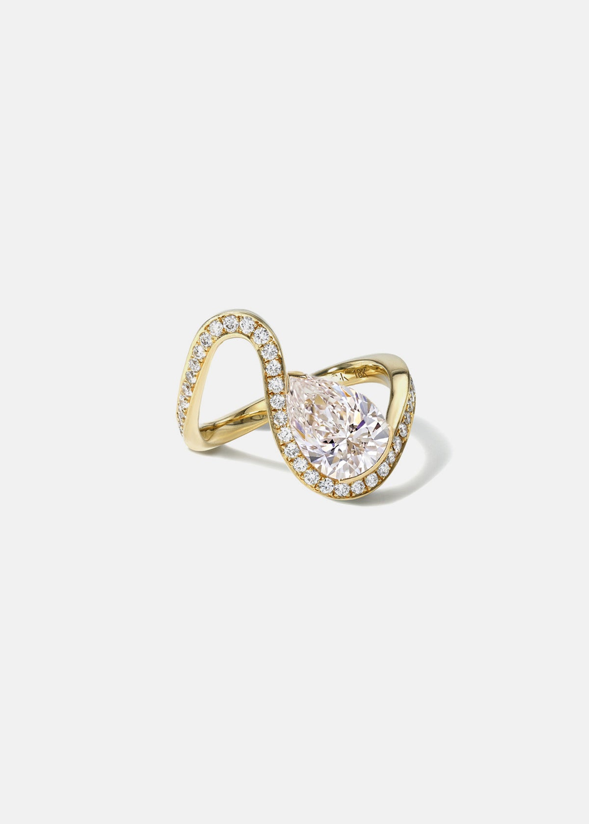 side view of a gold wave pavé band with a pear cut diamond -18K yellow gold
