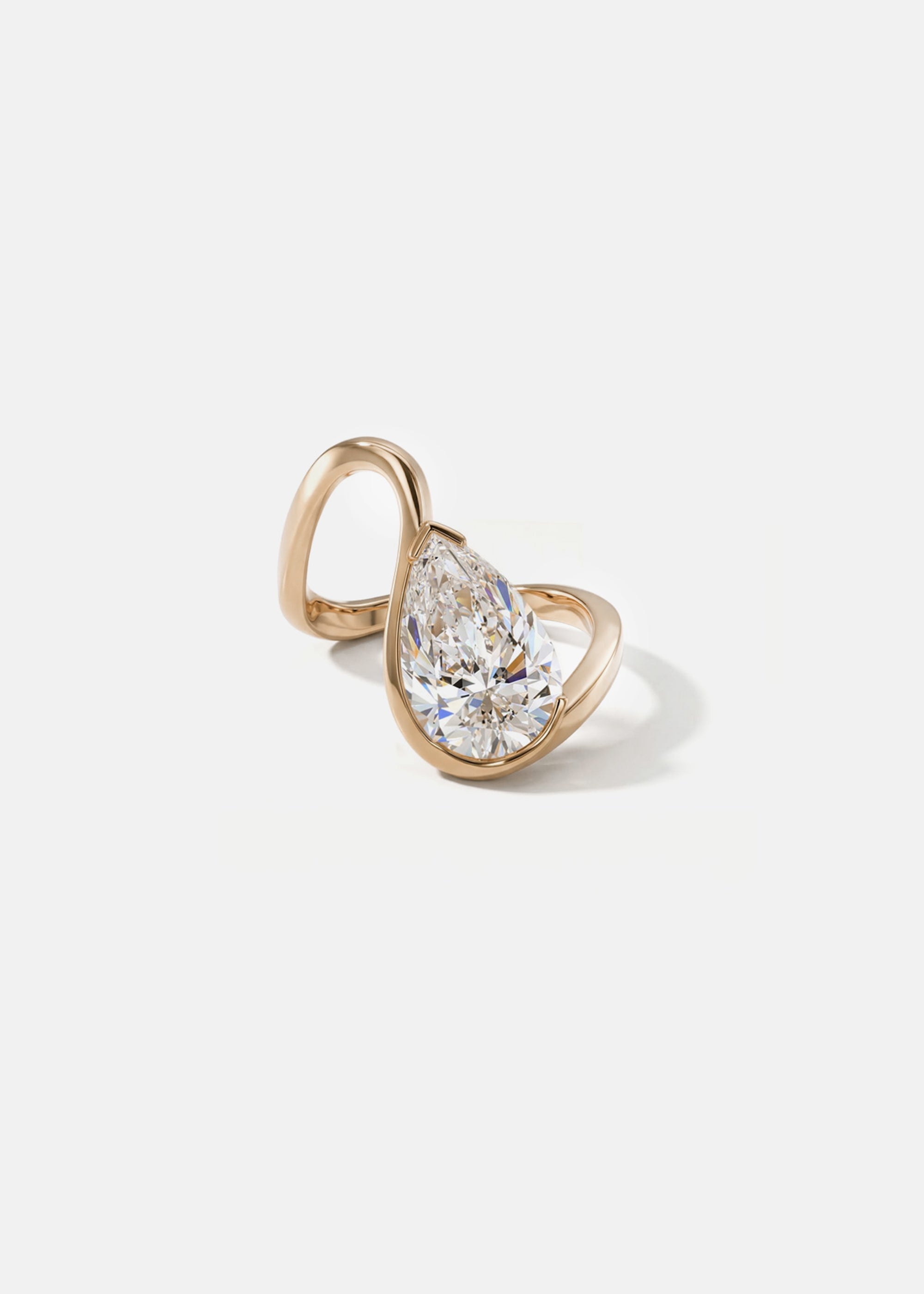 front view- 18k rose gold trace band with a floating pear cut diamond