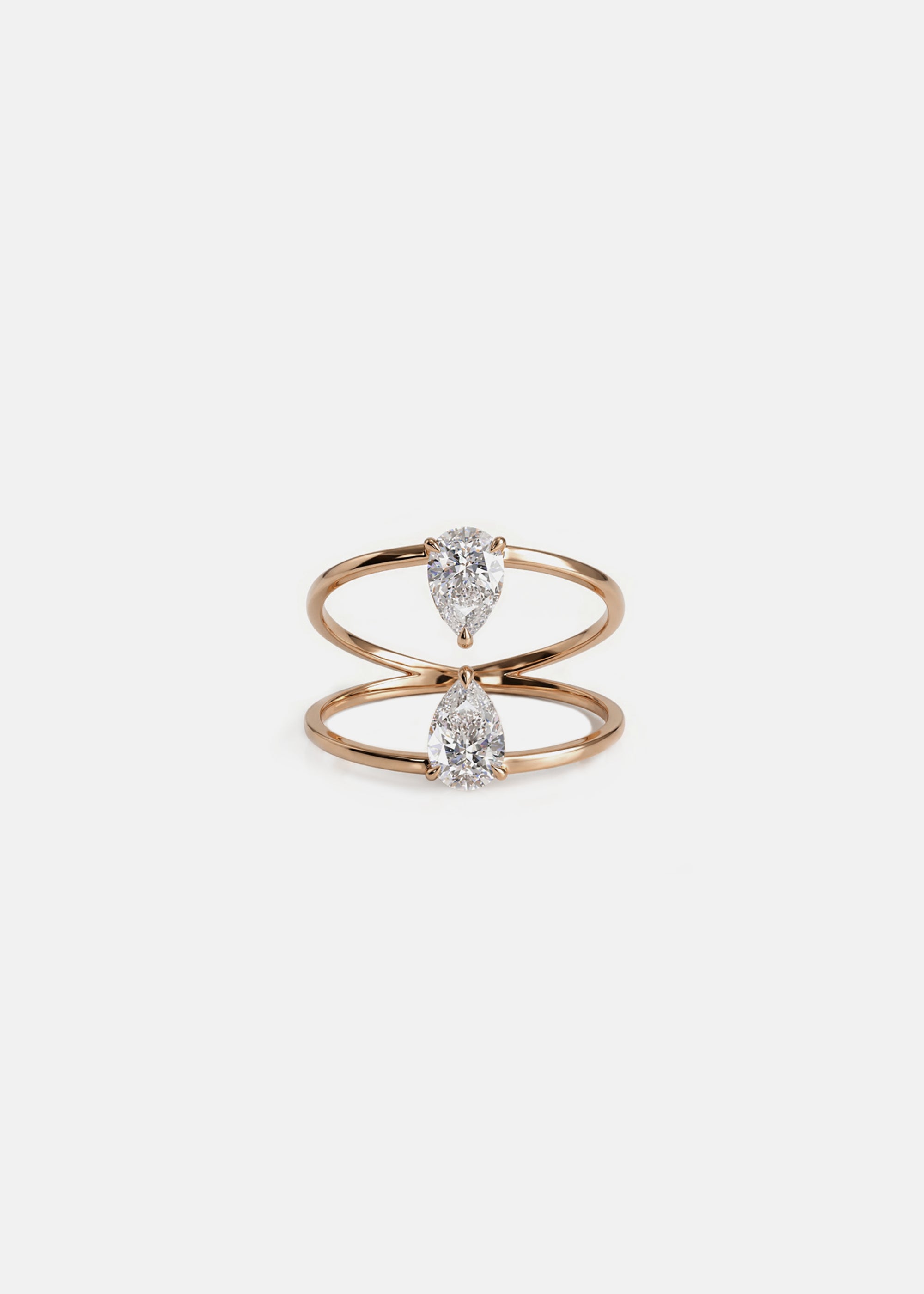 18k rose gold engagement ring with two touching pear-cut diamonds facing opposite directions..