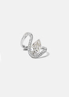 18k white gold trace band with halo of pavé diamonds along the band and a floating pear cut diamond slightly tilted