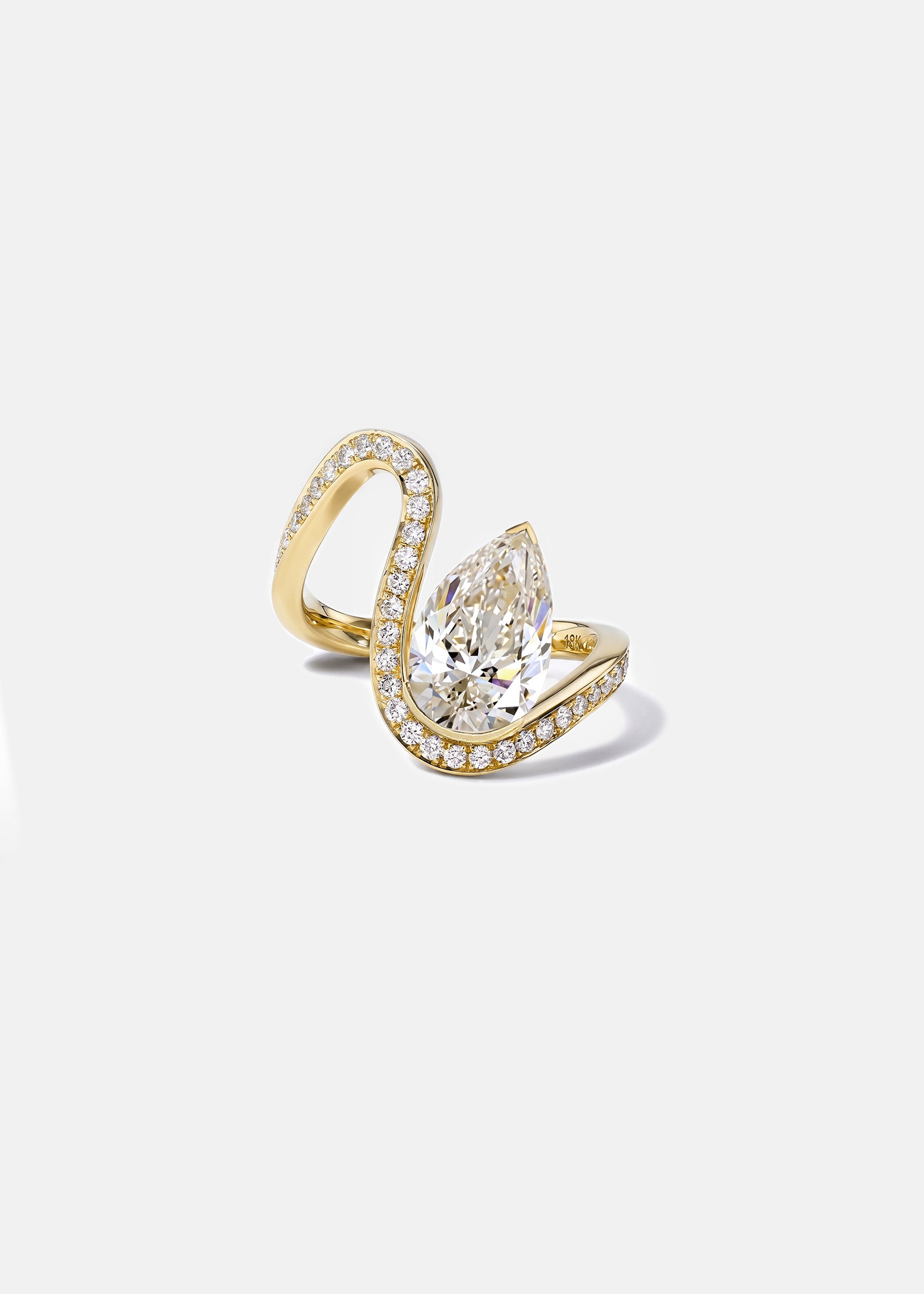 18k yellow gold trace band with pavé diamonds and a floating pear cut diamond slightly tilted