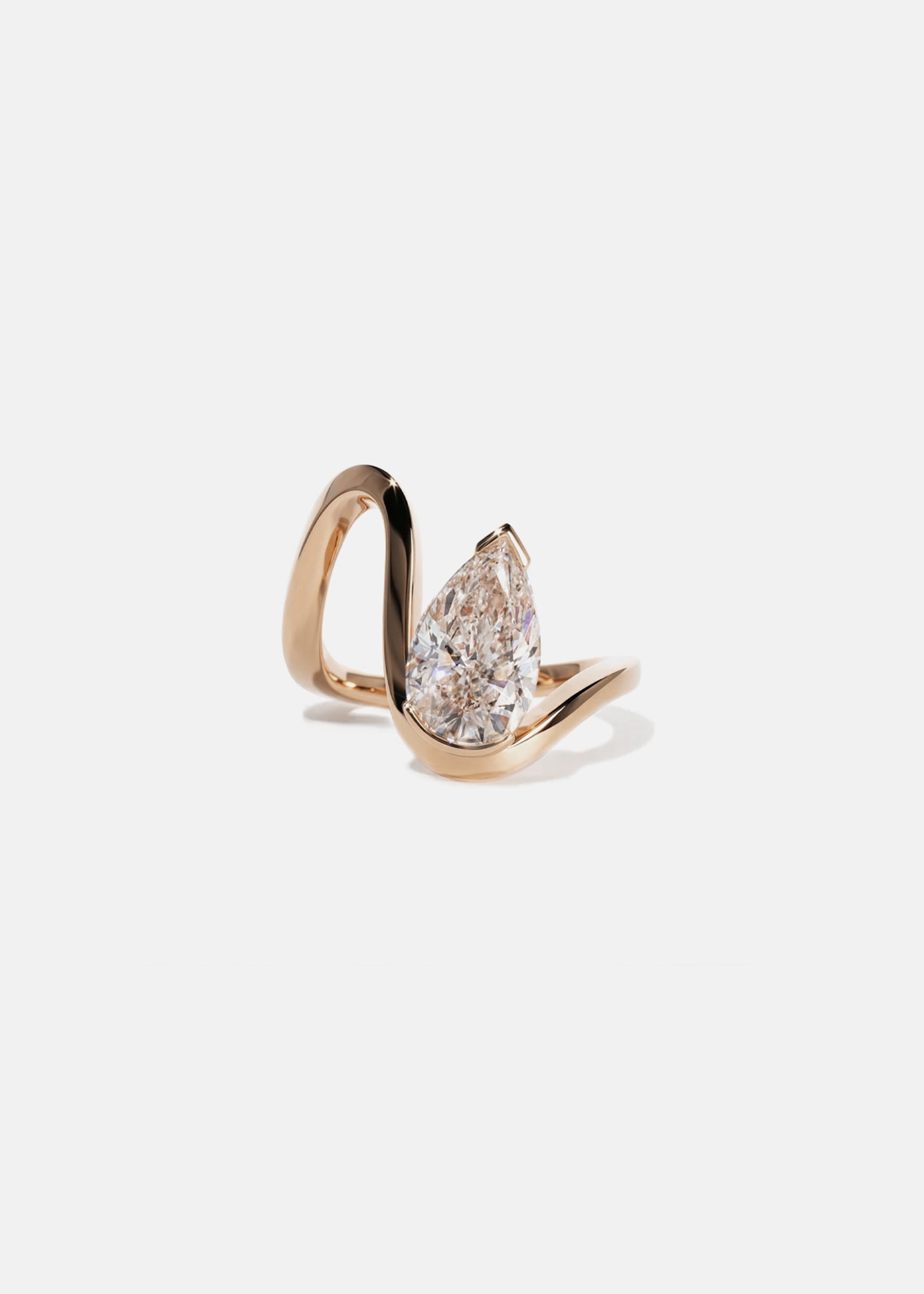 18k rose gold trace band with a floating pear cut diamond slightly tilted