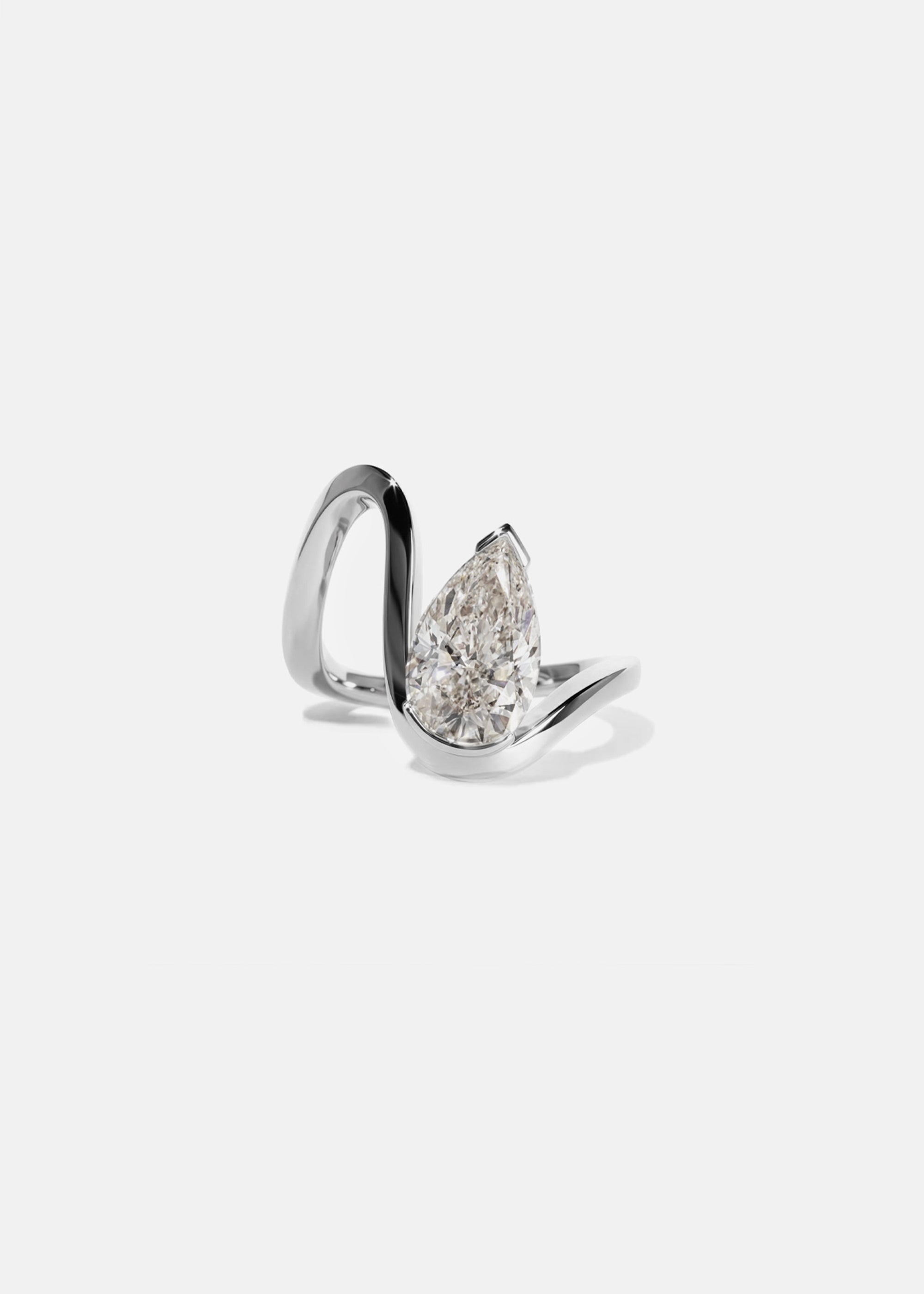 18k white gold trace band with a floating pear cut diamond slightly tilted