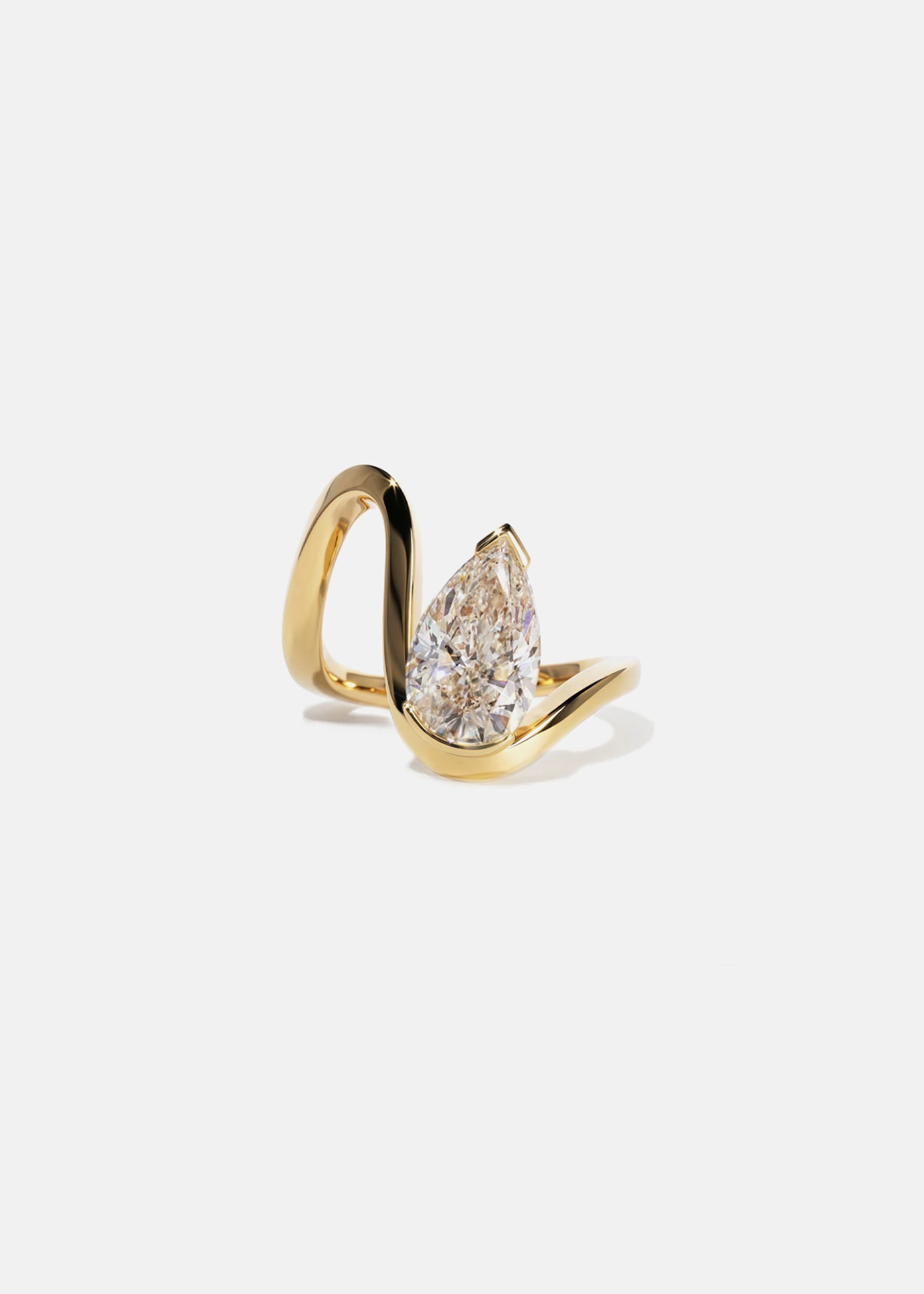 18k yellow gold trace band with a floating pear cut diamond slightly tilted