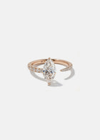 18k rose gold engagement ring with a floating marquise cut diamond anchored on a tapering micropavé diamond band