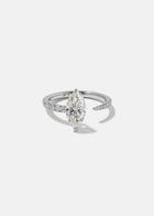 18k white gold engagement ring with a floating marquise cut diamond anchored on a tapering micropavé diamond band