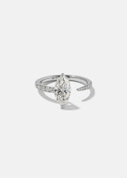 18k white gold engagement ring with a floating marquise cut diamond anchored on a tapering micropavé diamond band