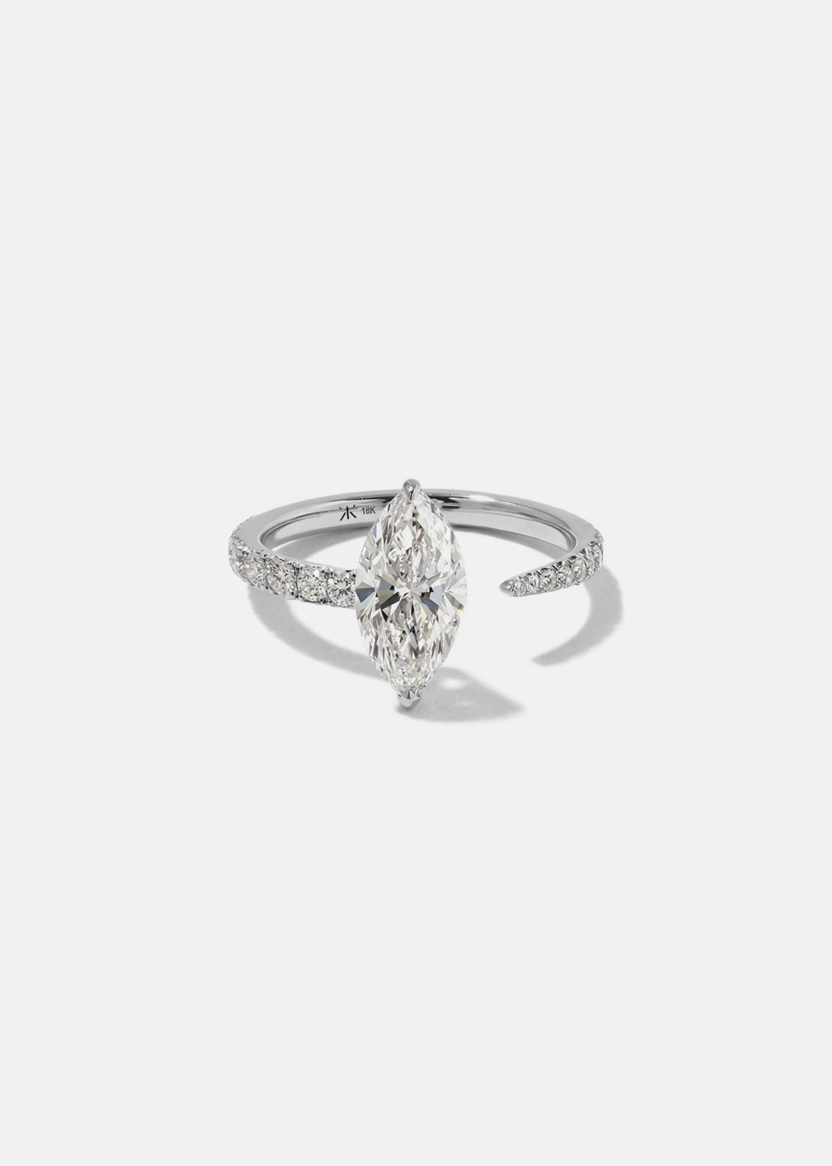 18k white gold engagement ring with a floating marquise cut diamond anchored on a tapering micropavé diamond band