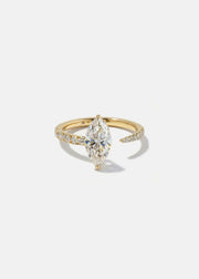 18k yellow gold engagement ring with a floating marquise cut diamond anchored on a tapering micropavé diamond band