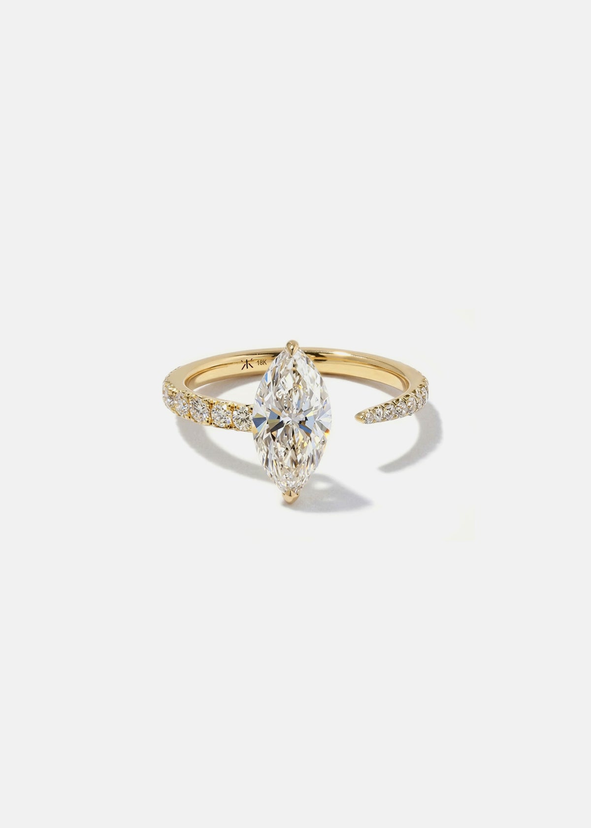 18k yellow gold engagement ring with a floating marquise cut diamond anchored on a tapering micropavé diamond band