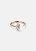 18k rose gold engagement ring with a prong-set marquise diamond anchored on a fluid, tapering open band