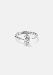 18k white gold engagement ring with a prong-set marquise diamond anchored on a fluid, tapering open band