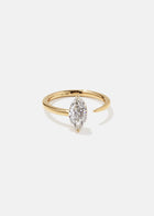 18k yellow gold engagement ring with a prong-set marquise diamond anchored on a fluid, tapering open band.