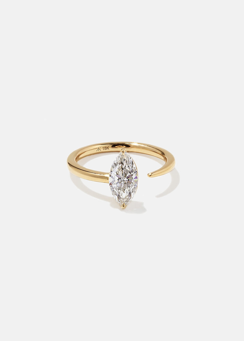 18k yellow gold engagement ring with a prong-set marquise diamond anchored on a fluid, tapering open band.