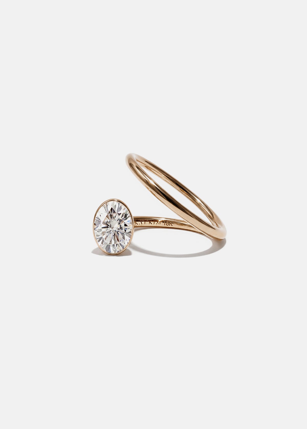 KATKIM 18k rose gold Oval Crescendo Flare Ring with a floating oval diamond and tilted wrapping band
