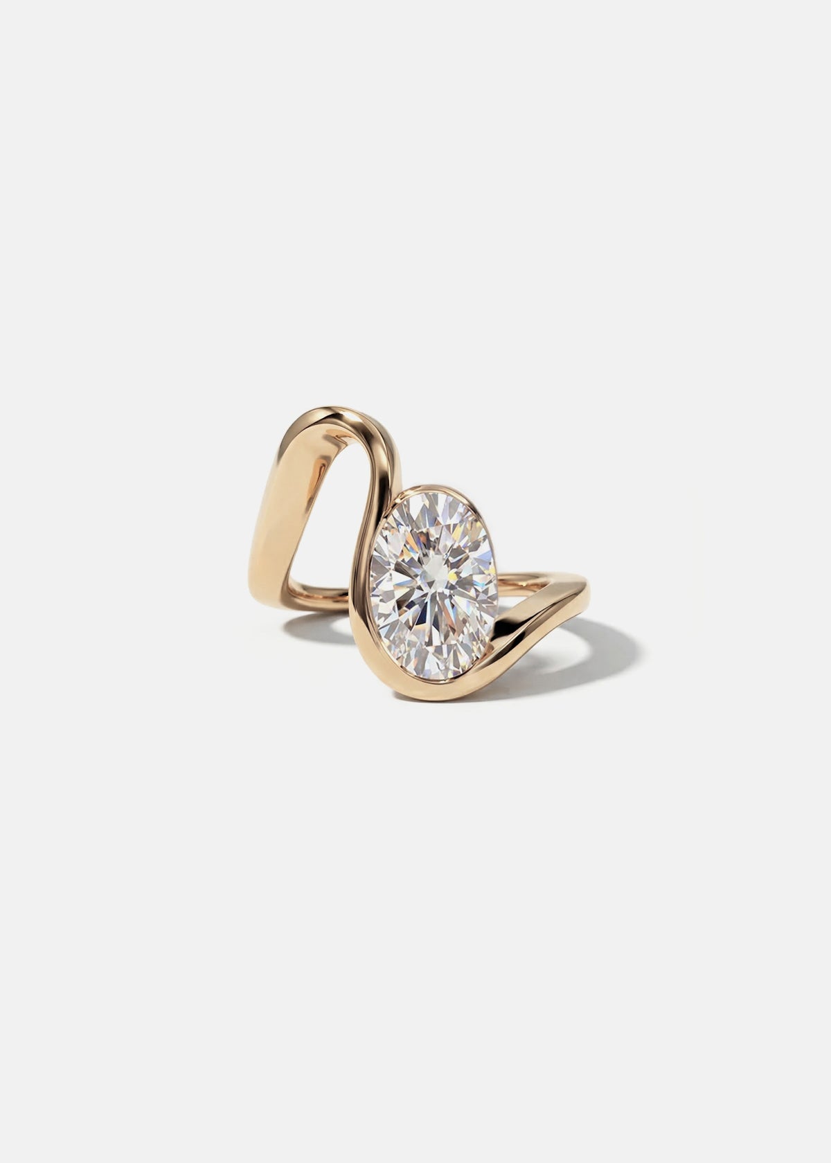 18k rose gold ring with a wide wavy band resembling a ribbon nestling an oval cut diamond