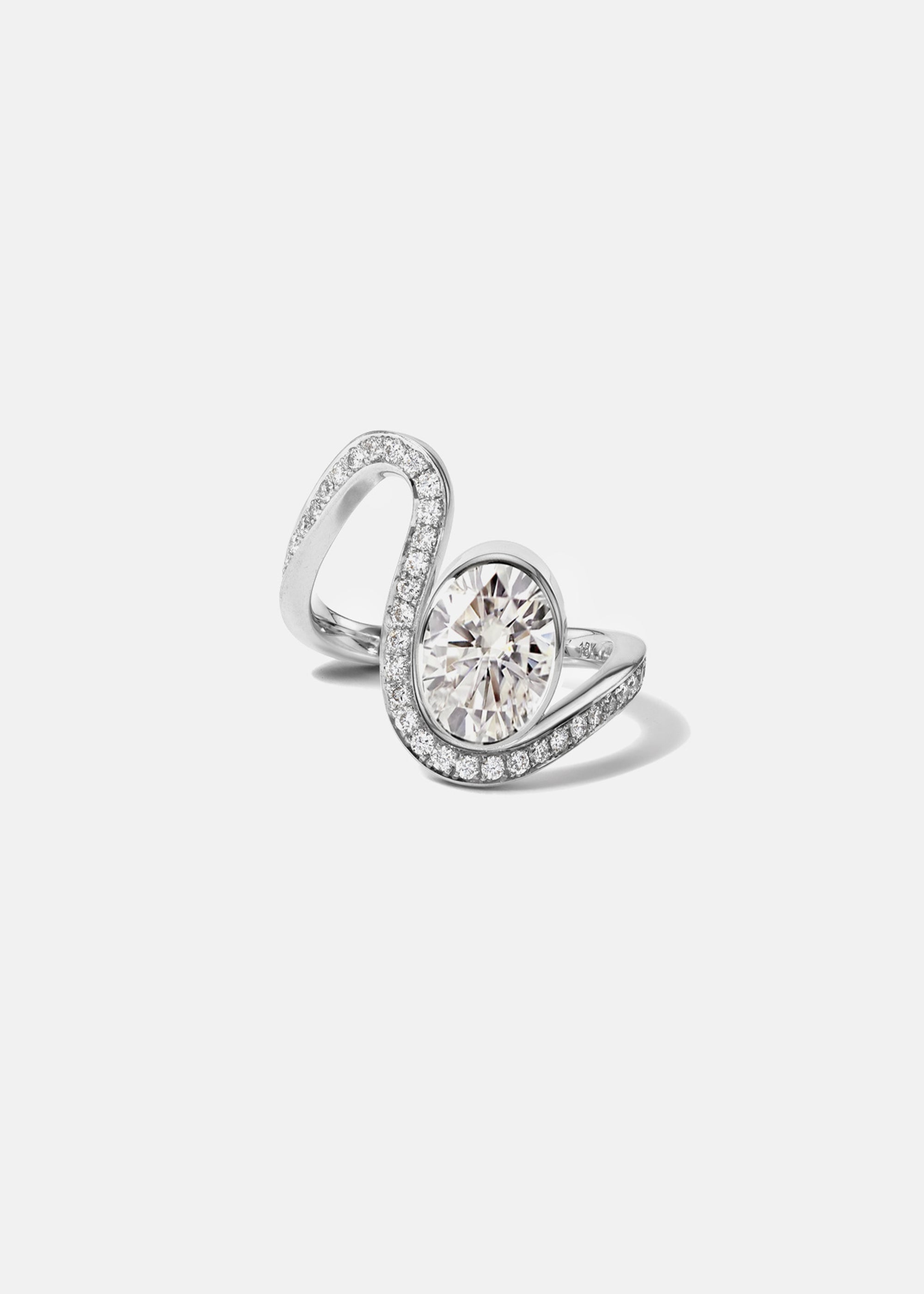 a 18k white gold ring featuring a large oval diamond with a curved band surrounded by a halo of small pavé-set diamonds.