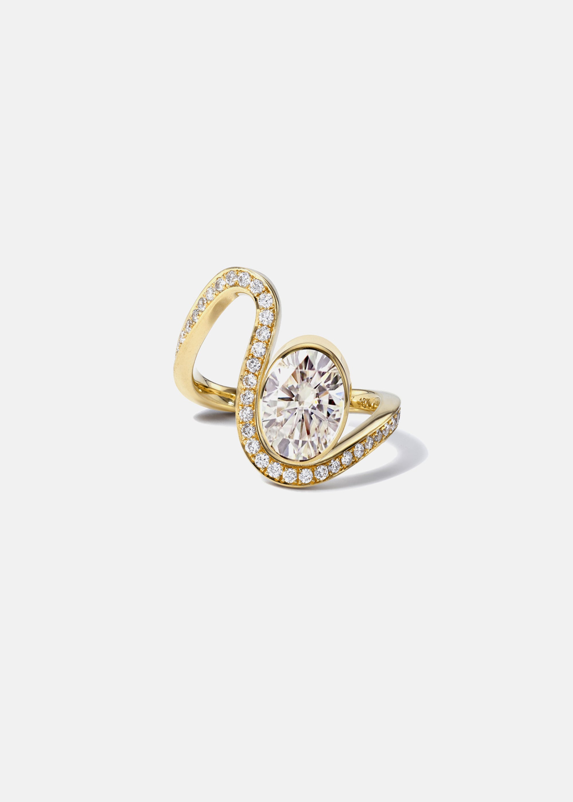 a 18k yellow gold ring featuring a large oval diamond with a curved band surrounded by a halo of small pavé-set diamonds.