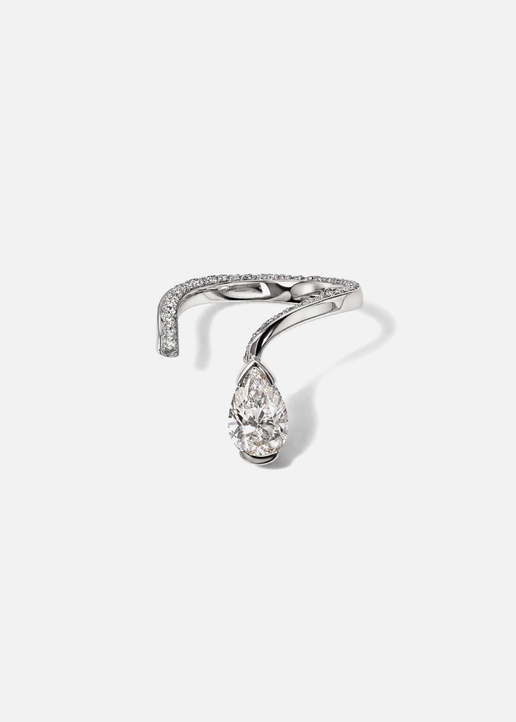 A 18k white gold open wrap ring featuring a pear-cut diamond and a pavé diamonds along the band.