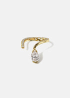 A 18k yellow gold open wrap ring featuring a pear-cut diamond and a pavé diamonds along the band.
