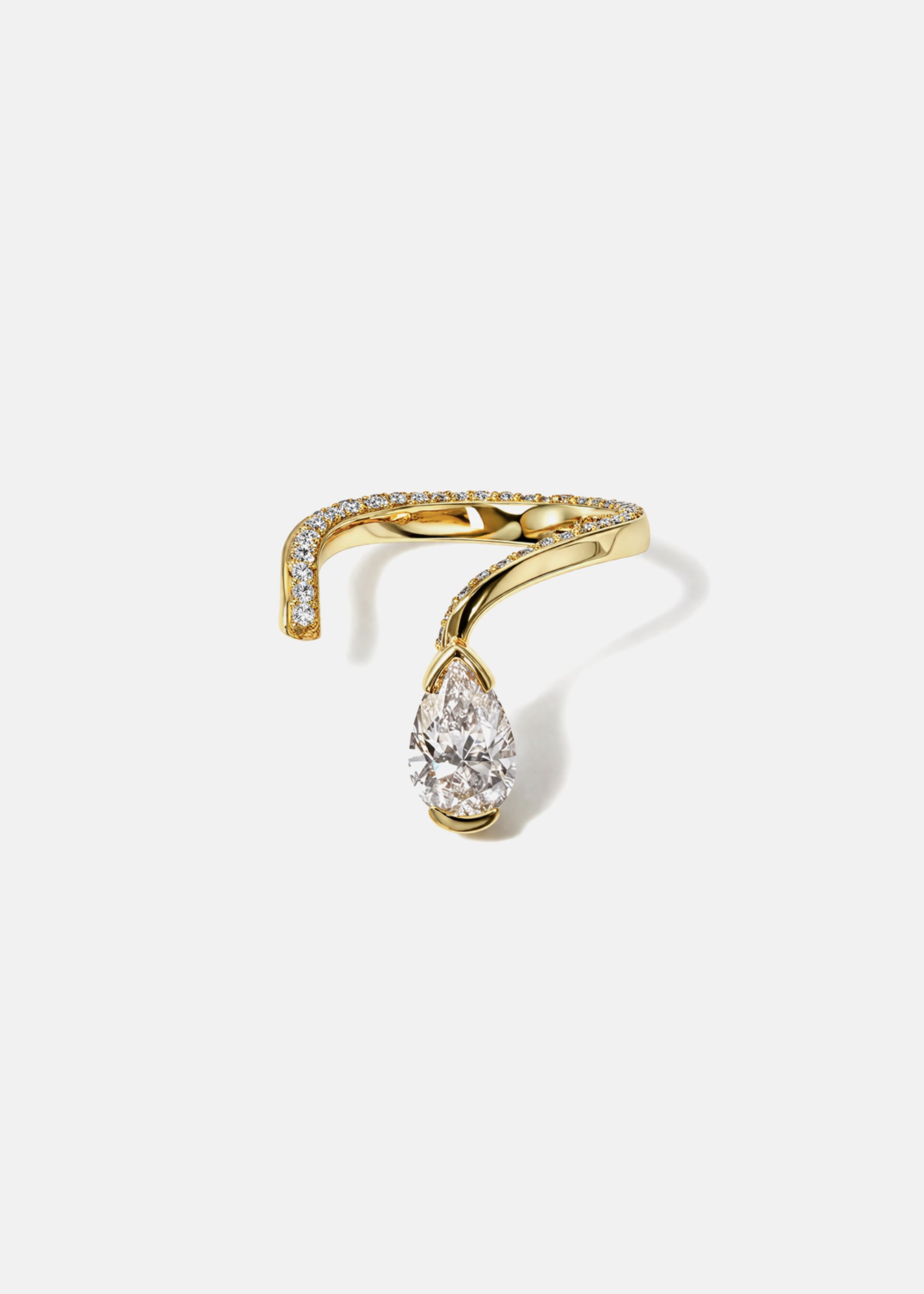 A 18k yellow gold open wrap ring featuring a pear-cut diamond and a pavé diamonds along the band.
