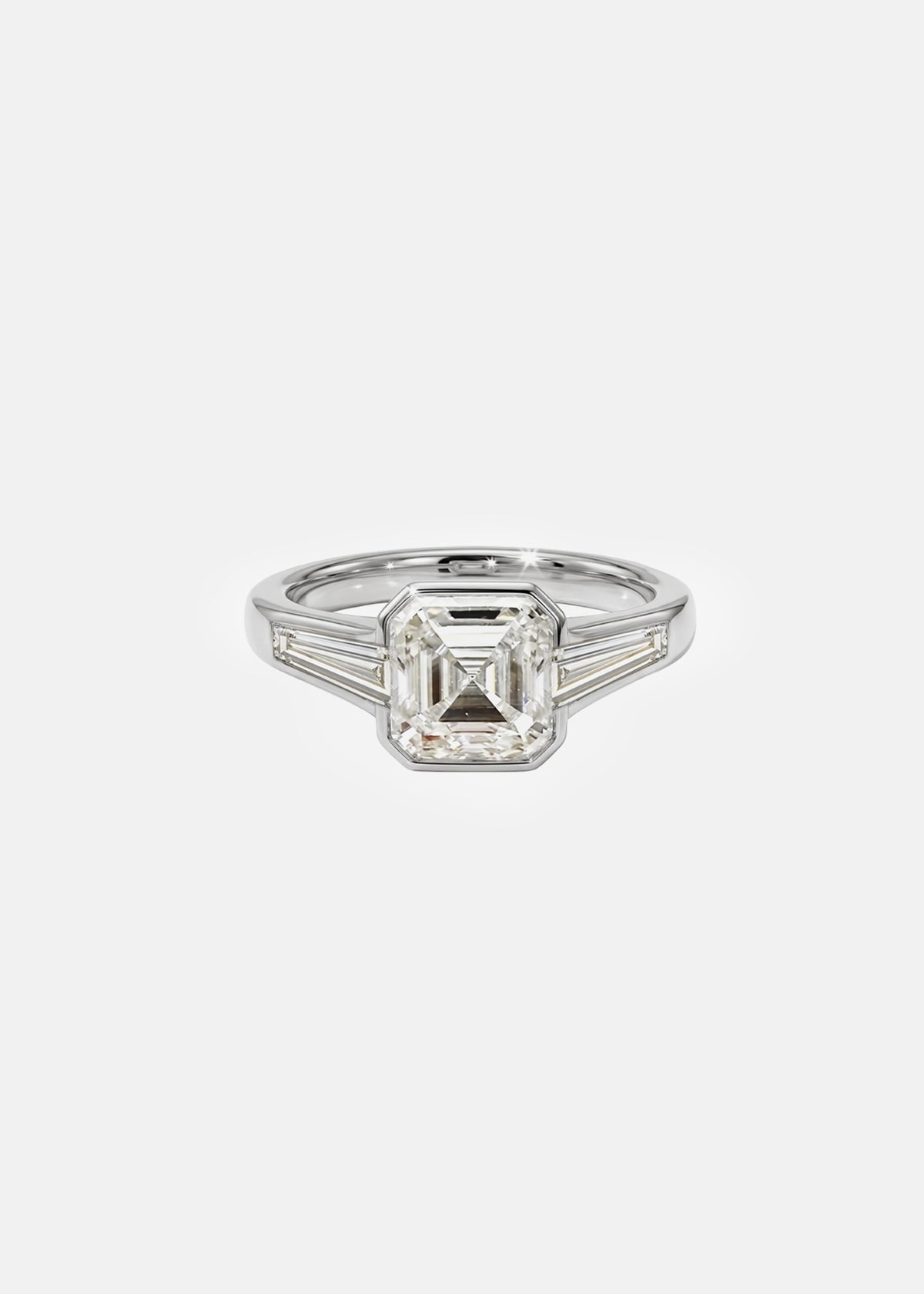 A 18k white gold ring featuring a central asscher-cut diamond flanked by two baguette-cut side stones
