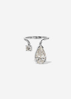 A 18k white gold ring featuring a large pear-cut diamond drop and a smaller round diamond accent on a curved band.